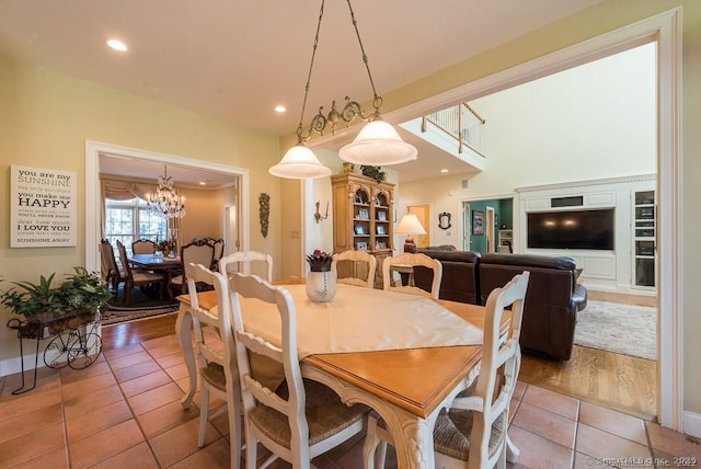 dining room with a chandelier and light tile patterned floors