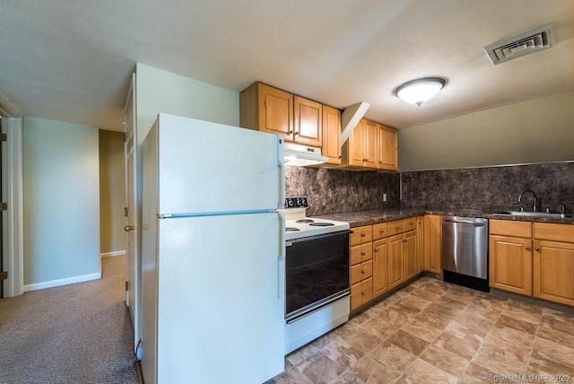 kitchen featuring white appliances, sink, and backsplash