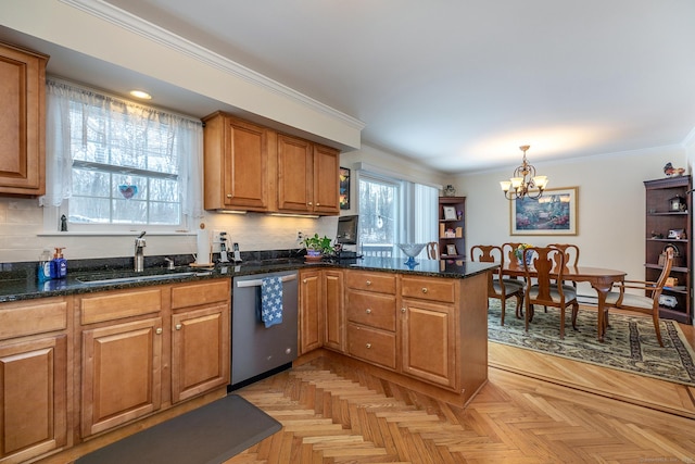 kitchen featuring hanging light fixtures, brown cabinetry, a sink, dishwasher, and a peninsula