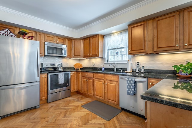 kitchen with stainless steel appliances, brown cabinets, crown molding, and a sink