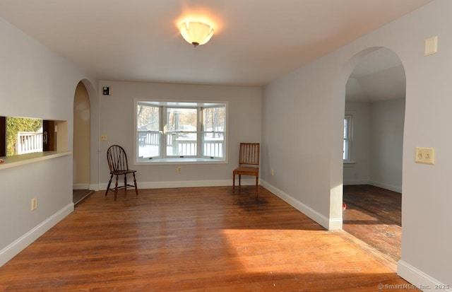 79 Jacob Rd, Southbury, CT 06488 - unfurnished room featuring arched walkways, a healthy amount of sunlight, and wood finished floors
