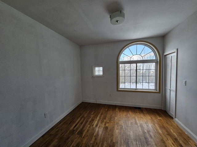 unfurnished room featuring dark hardwood / wood-style floors