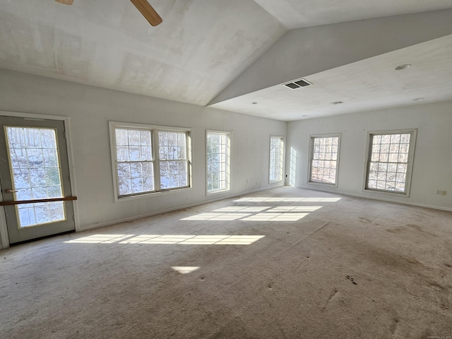 empty room featuring light carpet and high vaulted ceiling