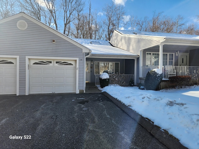 view of front facade with a garage and a porch