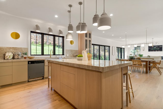 kitchen with decorative light fixtures, black dishwasher, decorative backsplash, light hardwood / wood-style floors, and a healthy amount of sunlight