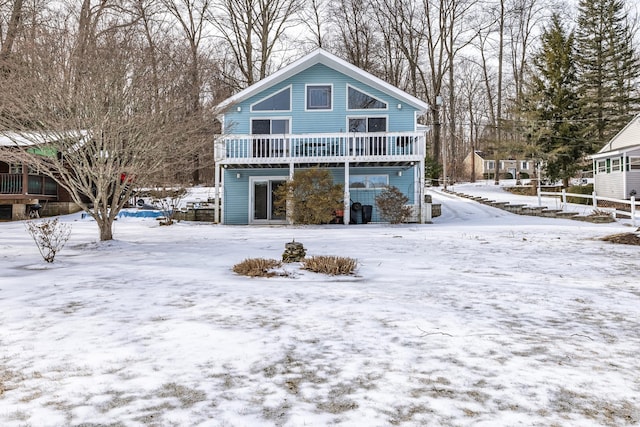 view of snow covered rear of property