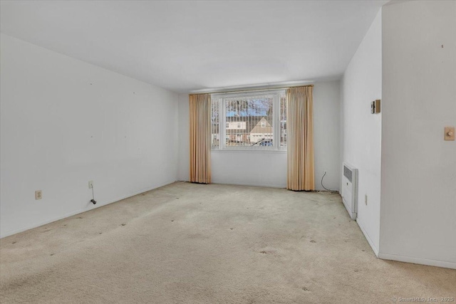 carpeted empty room featuring radiator