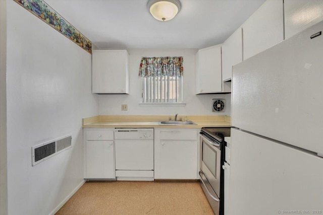 kitchen with sink, white appliances, and white cabinets