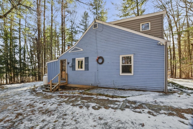 view of snow covered rear of property