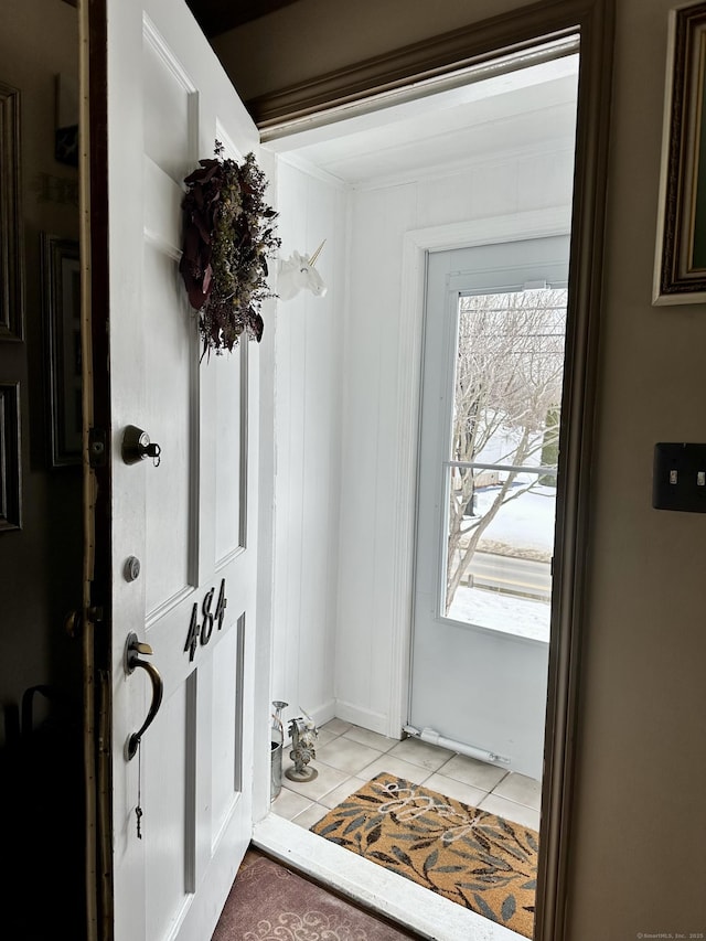 doorway featuring light tile patterned flooring