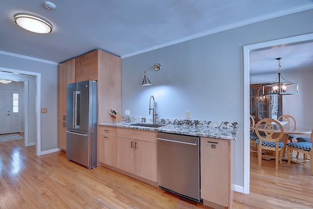 kitchen with sink, appliances with stainless steel finishes, light stone counters, ornamental molding, and light brown cabinetry