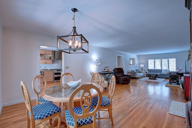 dining room with a chandelier and light hardwood / wood-style flooring