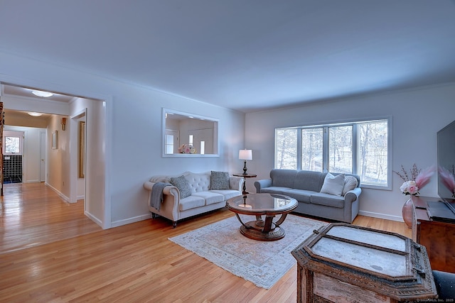 living room featuring light hardwood / wood-style flooring and ornamental molding