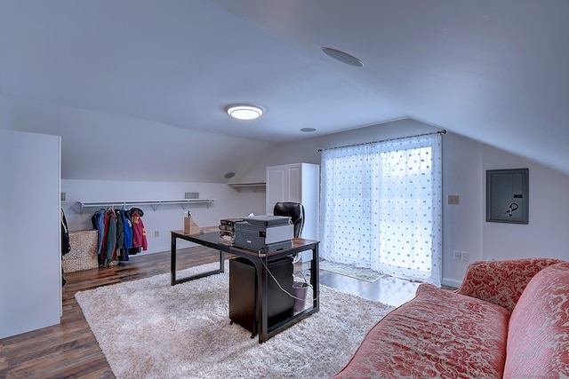 office space featuring lofted ceiling, dark hardwood / wood-style floors, and electric panel