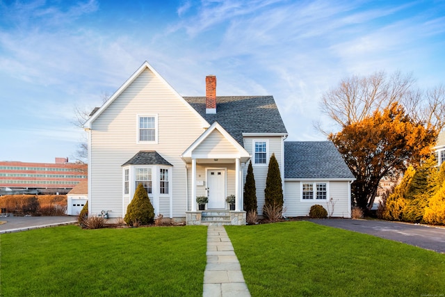 view of front of property with a garage and a front lawn