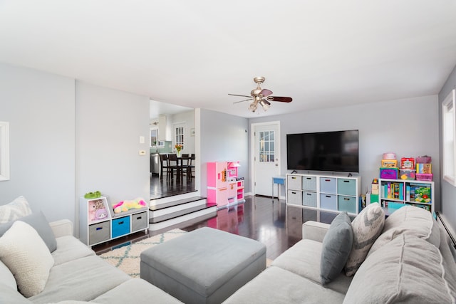 living room featuring dark hardwood / wood-style floors and ceiling fan