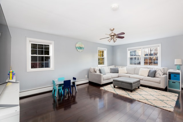 living room with dark wood-type flooring, a baseboard radiator, and ceiling fan