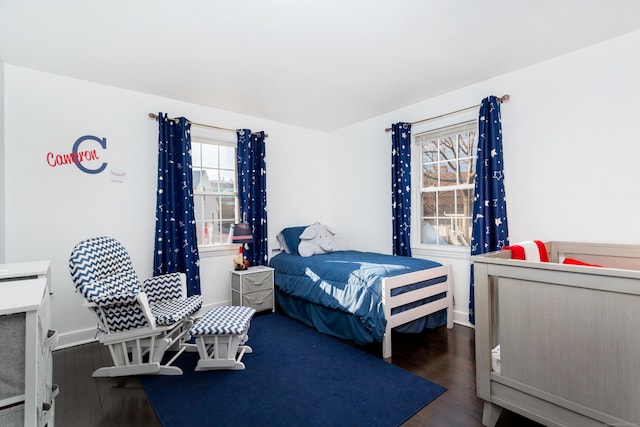 bedroom with dark hardwood / wood-style floors