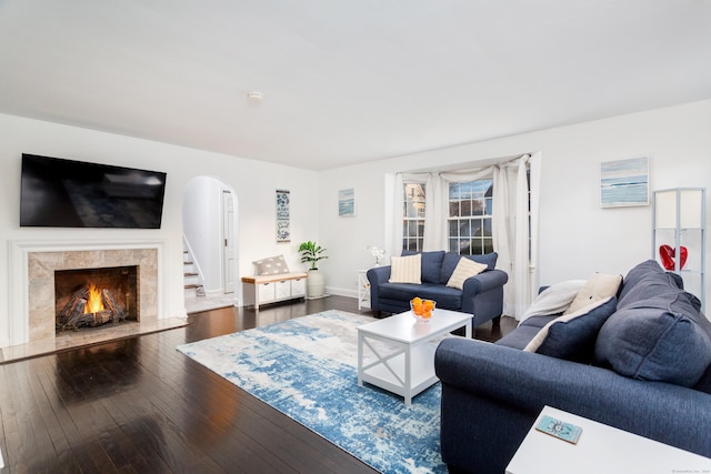 living room with a fireplace and dark hardwood / wood-style flooring