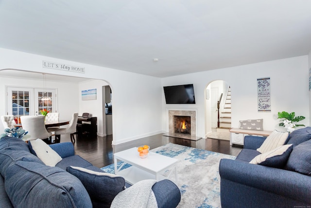 living room with dark hardwood / wood-style flooring and a high end fireplace