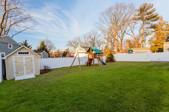 view of yard with a playground and a storage unit