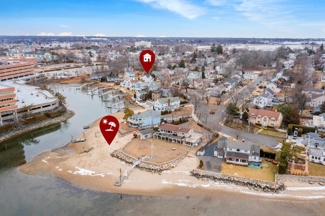 drone / aerial view with a beach view and a water view