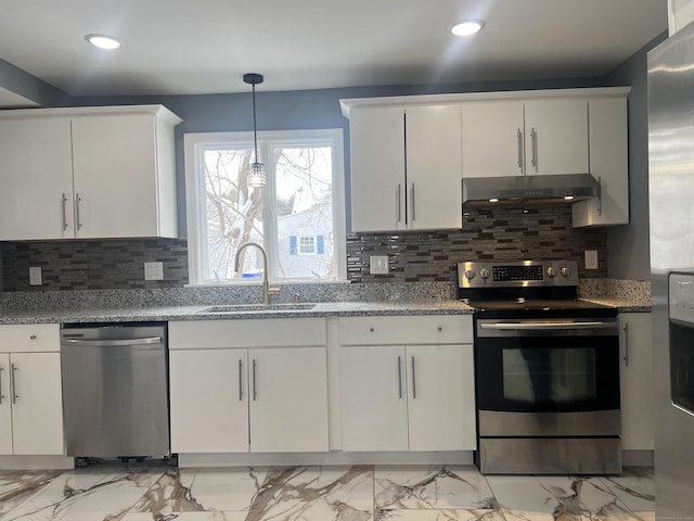 kitchen featuring sink, appliances with stainless steel finishes, white cabinetry, tasteful backsplash, and decorative light fixtures