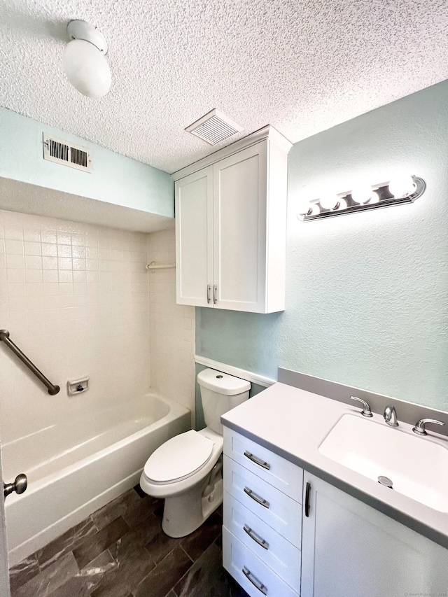 bathroom featuring toilet, visible vents, a textured ceiling, and a textured wall