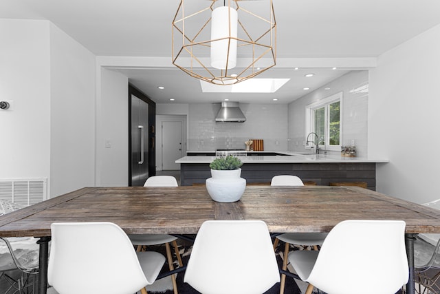 dining room with sink and a chandelier