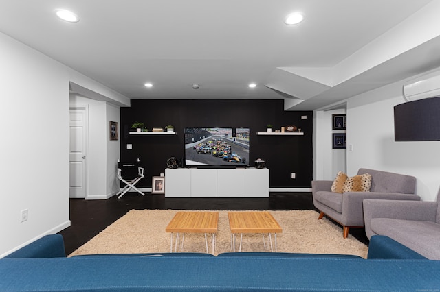 living room featuring a wall mounted air conditioner and dark hardwood / wood-style flooring