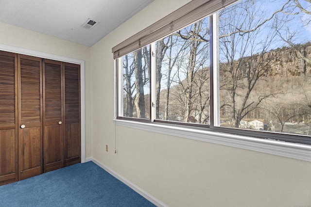 unfurnished bedroom with a closet and carpet flooring