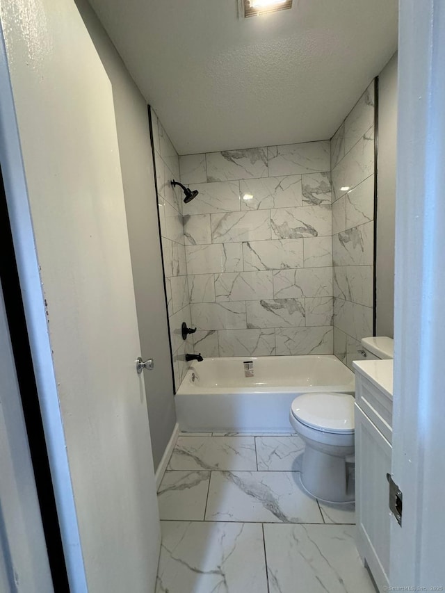 full bathroom featuring tiled shower / bath combo, vanity, a textured ceiling, and toilet