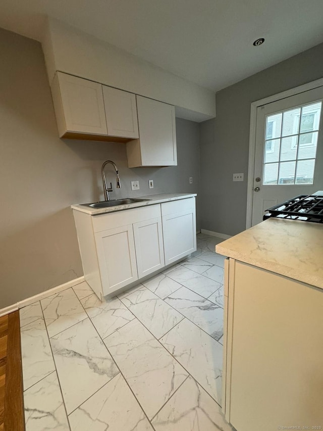 kitchen with white cabinetry and sink