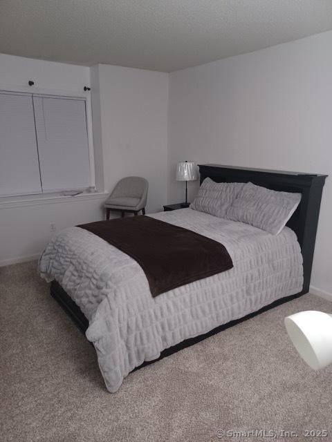 carpeted bedroom featuring a textured ceiling