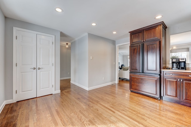 kitchen with paneled fridge and light hardwood / wood-style floors