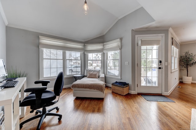 interior space featuring hardwood / wood-style flooring, vaulted ceiling, ornamental molding, and access to outside