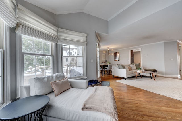 bedroom featuring crown molding, lofted ceiling, and light wood-type flooring