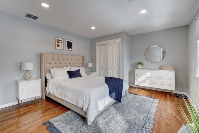 bedroom with hardwood / wood-style flooring and a closet