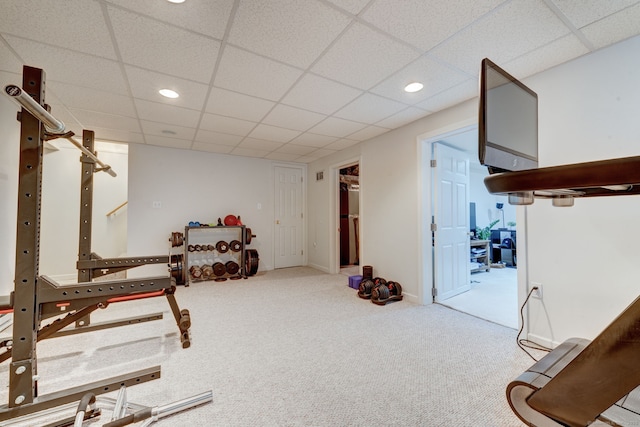 workout area with carpet floors and a drop ceiling