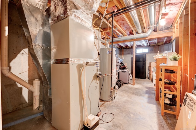 basement with black refrigerator and gas water heater