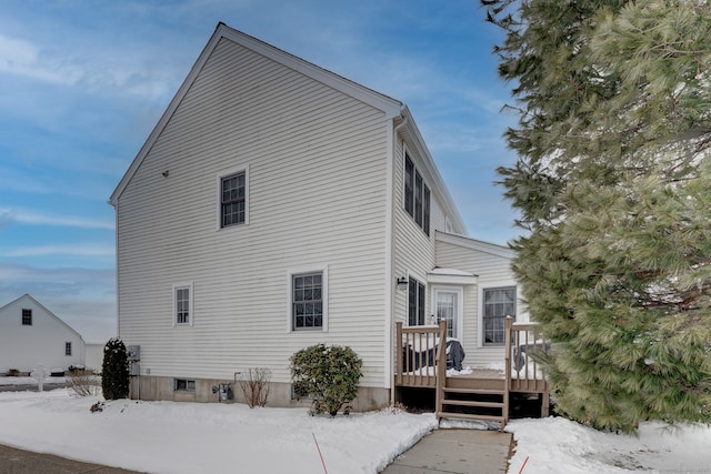 snow covered property featuring a wooden deck