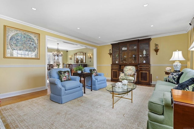 living room with recessed lighting, an inviting chandelier, wood finished floors, and crown molding