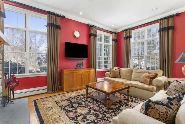 living area with a baseboard radiator, recessed lighting, wood finished floors, baseboard heating, and crown molding