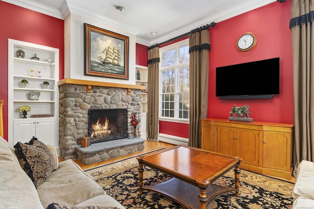 living area with a baseboard heating unit, built in features, a stone fireplace, and ornamental molding