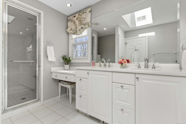 bathroom featuring double vanity, a stall shower, visible vents, and a sink