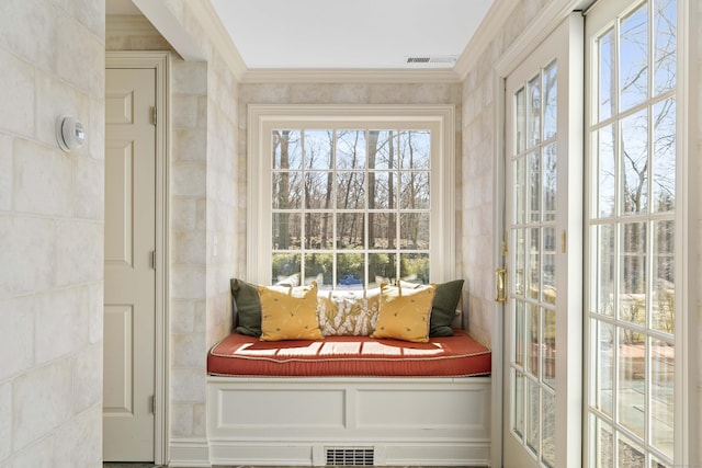 mudroom with tile walls, visible vents, and crown molding