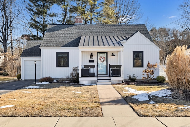 modern farmhouse style home featuring a garage and a porch