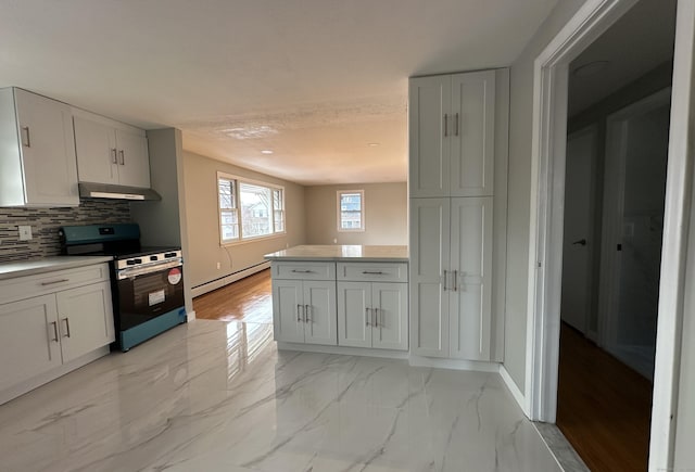 kitchen with tasteful backsplash, stainless steel electric stove, white cabinets, and baseboard heating