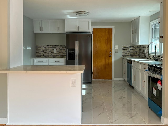 kitchen featuring white cabinetry, stainless steel appliances, kitchen peninsula, and sink