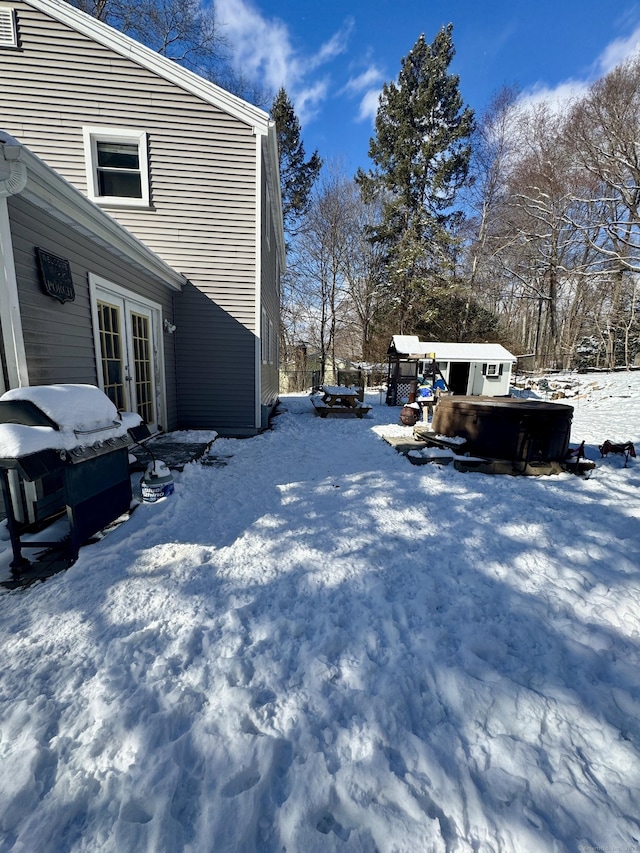 snowy yard featuring a hot tub